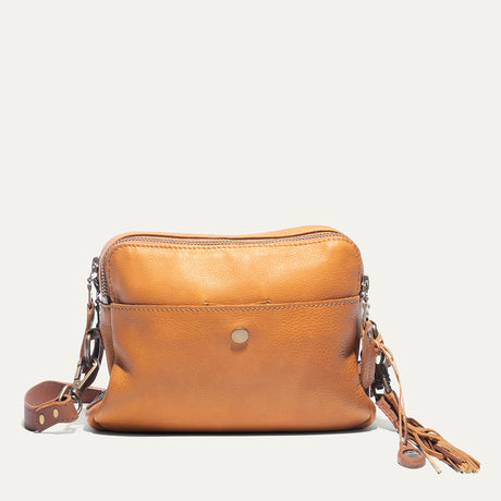 Tan leather crossbody bag, front view, with zip top, snap front pocket, and fringe tassel zipper pull