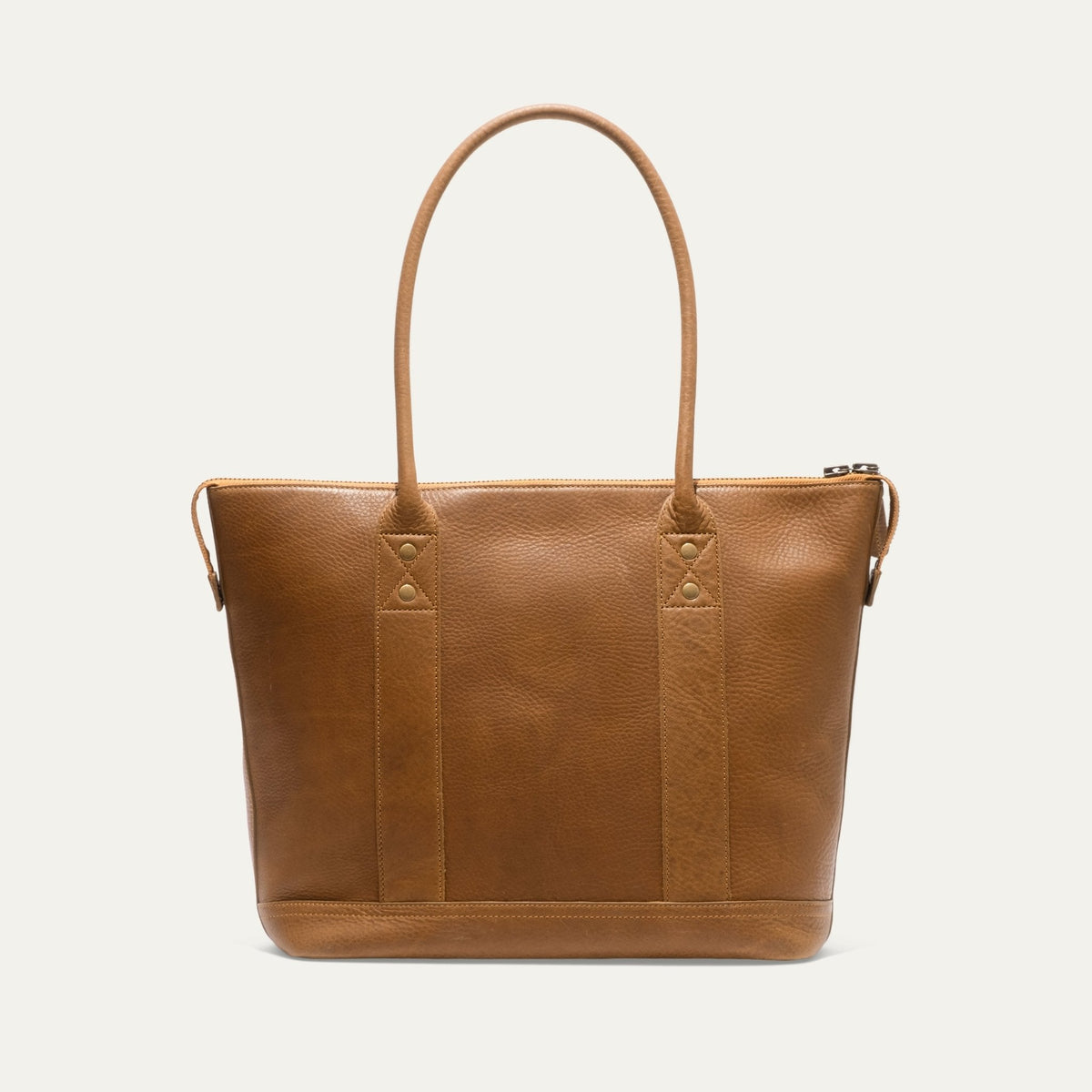 Tan pebbled leather zip tote, straight-on front view showing the WILL brand patch and zip pull
