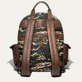 Back view of the green digital camo Canvas + Leather Backpack showing the brown leather top handle, padded shoulder straps, and rear zip pocket.
