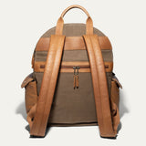 Back view of the olive canvas Canvas + Leather Backpack showing the tan leather top handle, padded shoulder straps, and rear zip pocket.