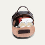 Interior view of the dark brown leather backpack open, showing the suede-lined main compartment and interior slip pocket.