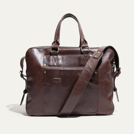 Dark brown leather briefcase, front pocket view, with zip top, snap-top front pocket, and adjustable shoulder strap