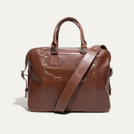 Tan leather briefcase, front pocket view, with zip top, snap-top front pocket, and adjustable shoulder strap