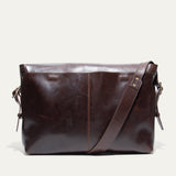 Will Leather Goods Field Messenger bag in dark brown leather, back view standing on a white background.
