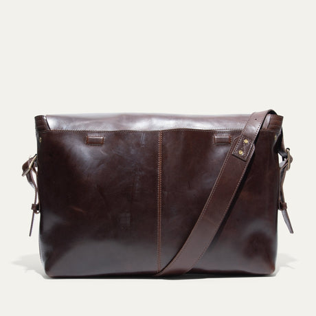 Will Leather Goods Field Messenger bag in dark brown leather, back view standing on a white background.