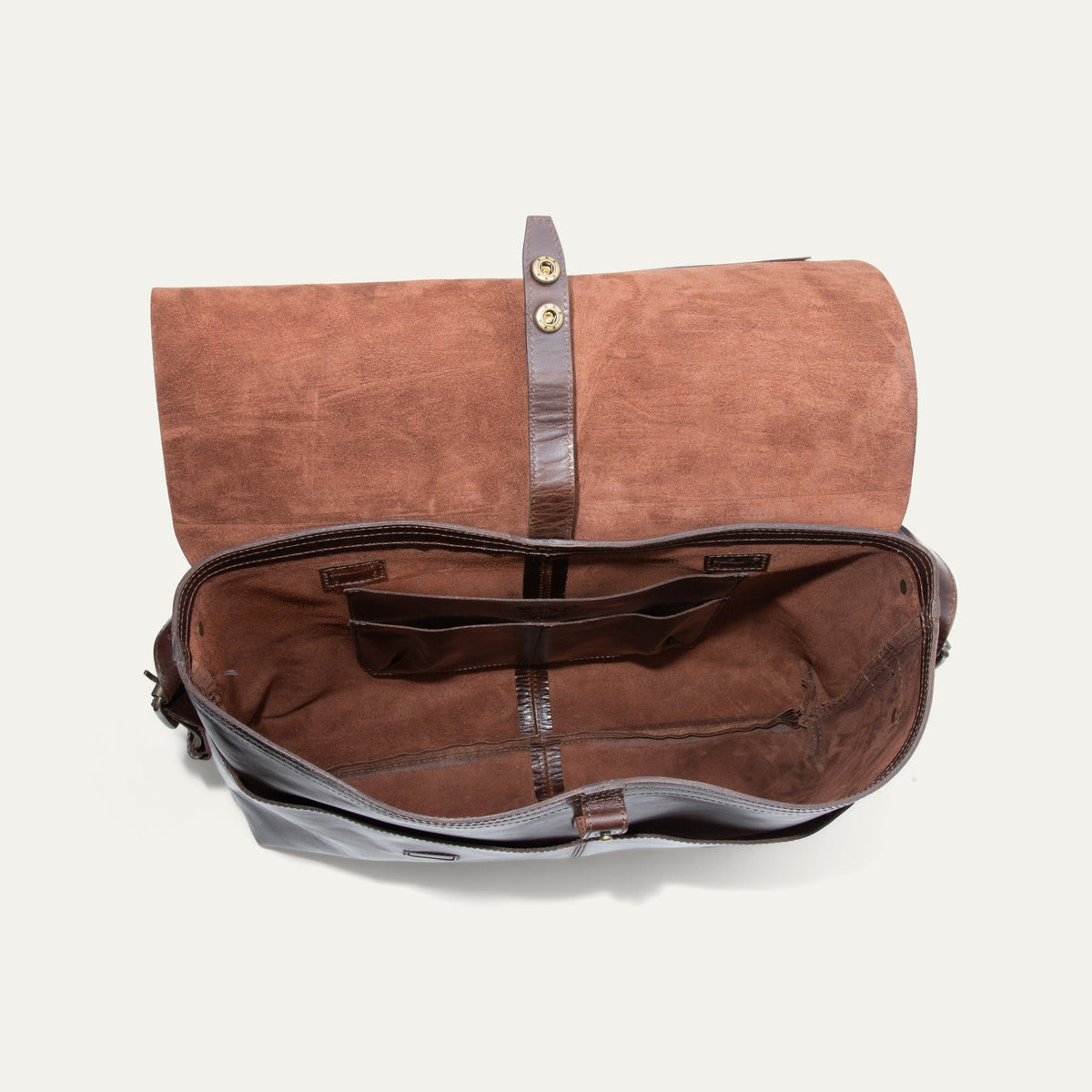 Will Leather Goods Field Messenger bag in dark brown leather, opened flat and empty showing the suede-lined interior, snap closure strap, and organizer pockets.