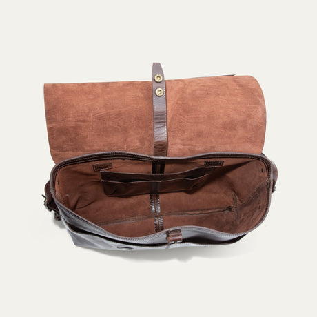 Will Leather Goods Field Messenger bag in dark brown leather, opened flat and empty showing the suede-lined interior, snap closure strap, and organizer pockets.
