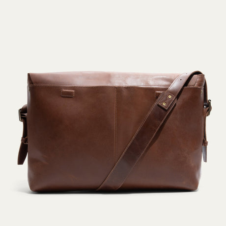 Will Leather Goods Field Messenger bag in tan leather, back view standing upright with the crossbody strap draped diagonally across the front.