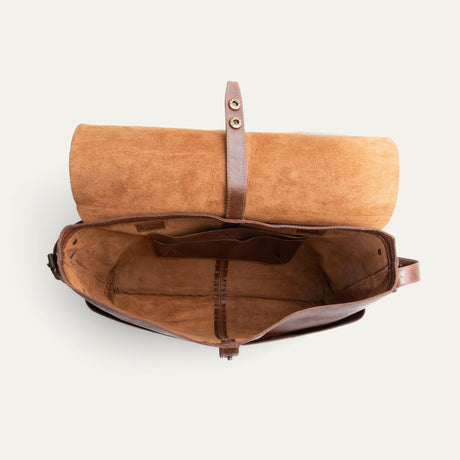 Will Leather Goods Field Messenger bag in tan leather, opened flat and packed with a laptop, notebooks, pens, and a round travel case inside the suede-lined interior.