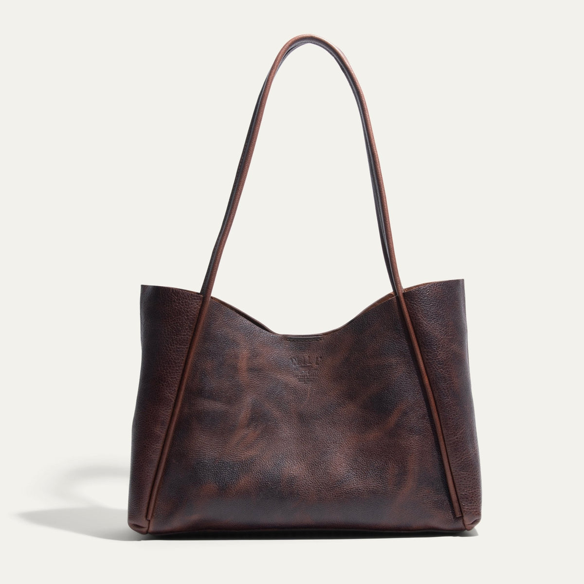 Will Leather Goods Workshop Tote in brown pebbled leather with a two-tone patina, shown front-facing on a white background with tall shoulder straps.