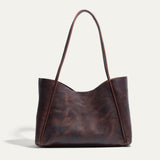 Will Leather Goods Workshop Tote in brown pebbled leather with a two-tone patina, shown front-facing on a white background with tall shoulder straps.
