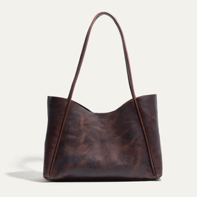 Will Leather Goods Workshop Tote in brown pebbled leather with a two-tone patina, shown front-facing on a white background with tall shoulder straps.