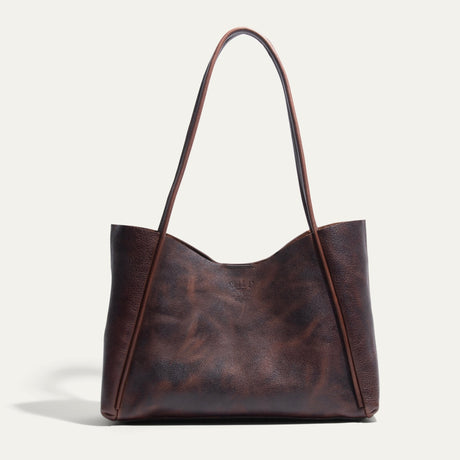 Will Leather Goods Workshop Tote in brown pebbled leather with a two-tone patina, shown front-facing on a white background with tall shoulder straps.