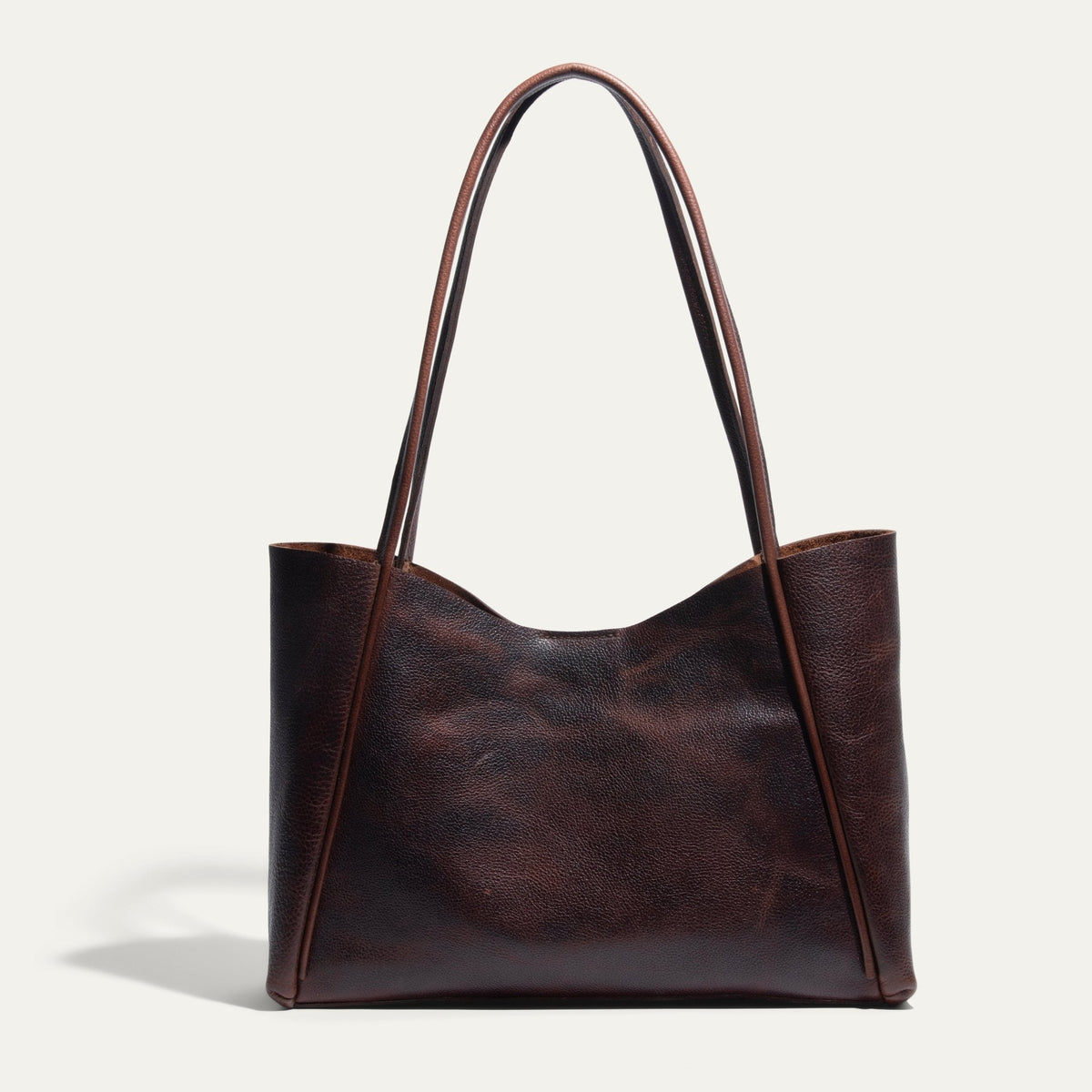 Front-facing view of the brown Workshop Tote in pebbled leather on a white background.