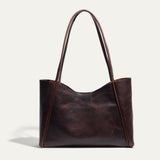 Front-facing view of the brown Workshop Tote in pebbled leather on a white background.