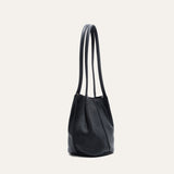 Black leather bucket bag, three-quarter angle view showing the shape and stitching