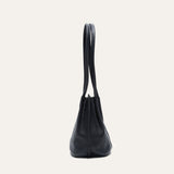 Black leather bucket bag, side profile view showing the rounded gusset