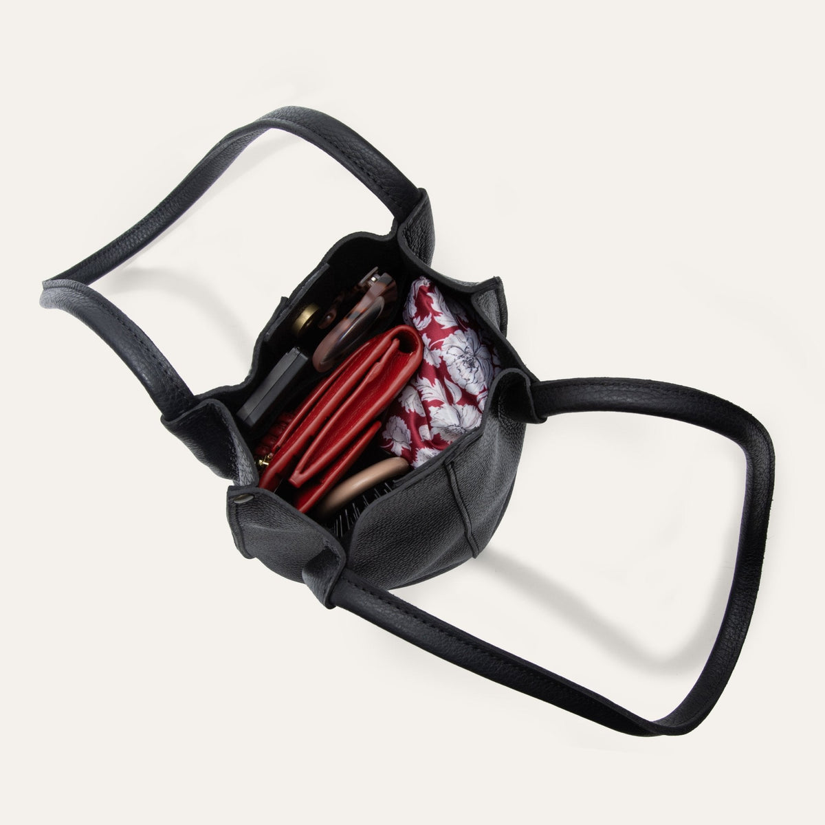 Close-up of the black leather bucket bag's interior magnetic snap closure
