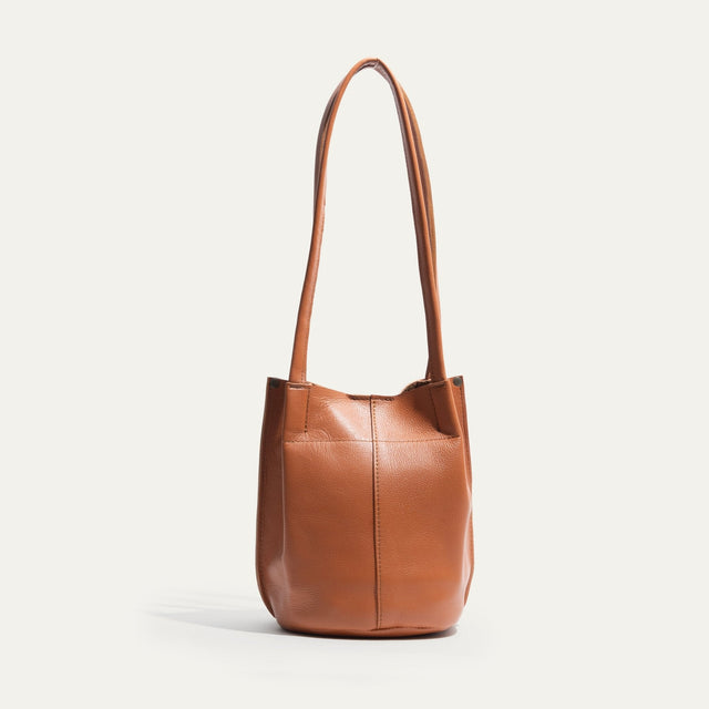 Will Leather Goods caramel leather bucket bag, front view with long shoulder straps