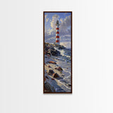 Framed Canvas Print Skinny Art of a Majestic Lighthouse Standing Tall Against a Bright Blue Sky with Waves Crashing on Rocky Shores, Perfect Tall Art