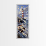 Framed Canvas Print Skinny Art of a Majestic Lighthouse Standing Tall Against a Bright Blue Sky with Waves Crashing on Rocky Shores, Perfect Tall Art