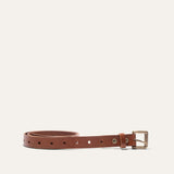Will Leather Goods Bridal Belt in cognac leather, laid flat in a coil with the antique brass roller buckle and embossed cow-head snaps visible, on a white background.