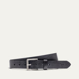 Will Leather Goods Bridal Belt in black leather, laid flat with the antique silver roller buckle and embossed cow-head logo near the tip, on a white background.