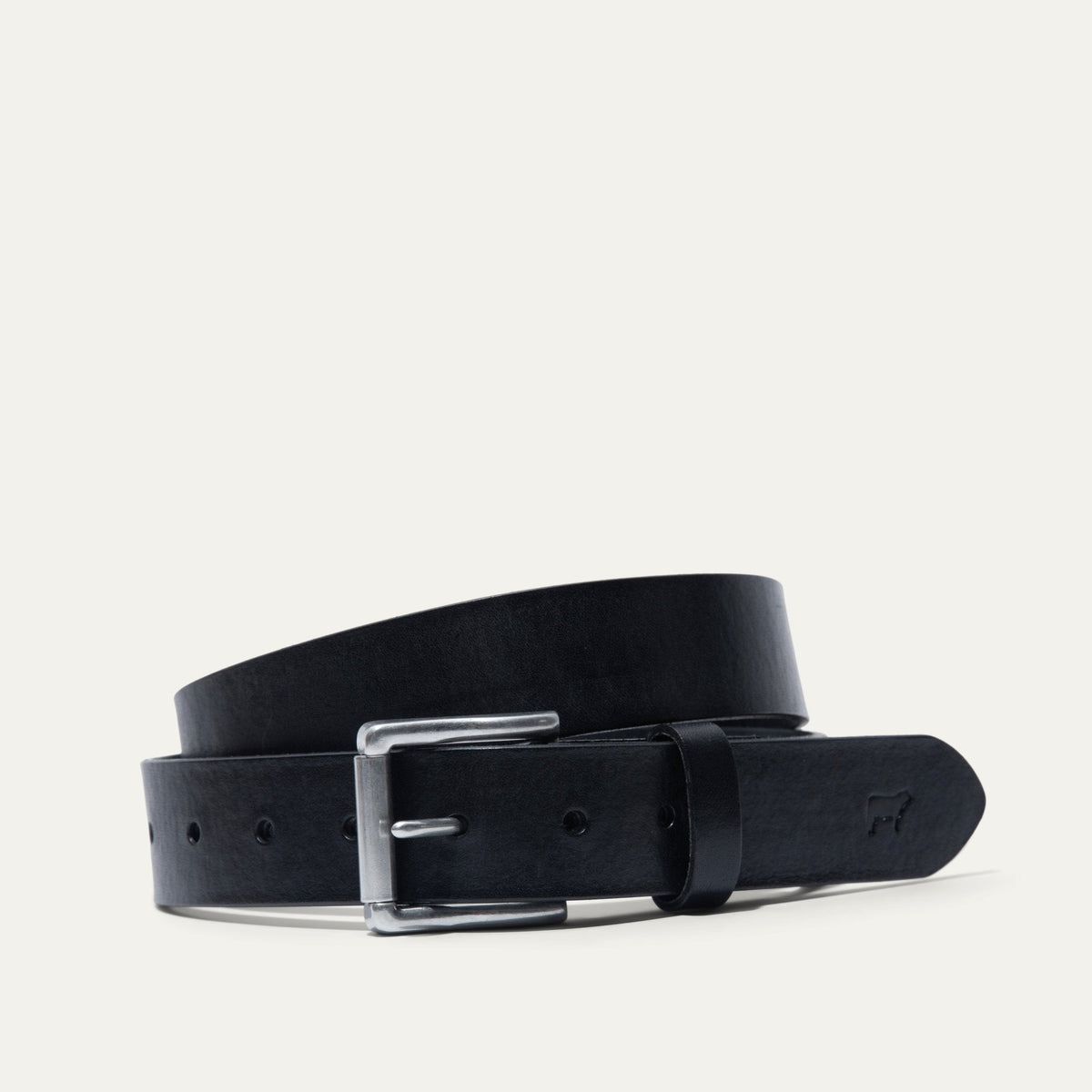 Will Leather Goods black leather belt coiled, showing the brushed nickel roller buckle