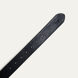 Close-up of the black leather belt's tip, showing the embossed cattle logo and adjustment holes