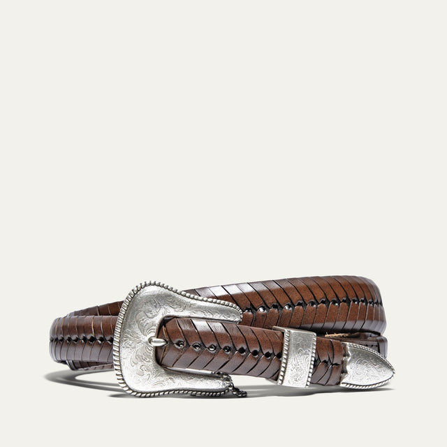 Cognac brown tapered leather belt with woven lace-wrapped strap texture and an ornate engraved silver western buckle set, coiled view.