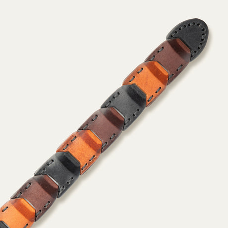 Close-up view of the tapered tip end of the tri-color Hand Laced Link Belt, showing the black, brown, and cognac hand-laced link panels.