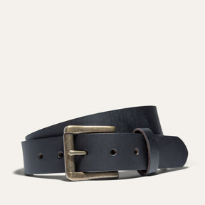 Black Edge Jean Belt by WILL Leather Goods in black leather with an antique brass roller buckle, coiled front product view on a white background.