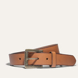 Close-up of the Black Edge Jean Belt buckle in cognac leather with a black burnished edge, showing the antique brass buckle and rivets.