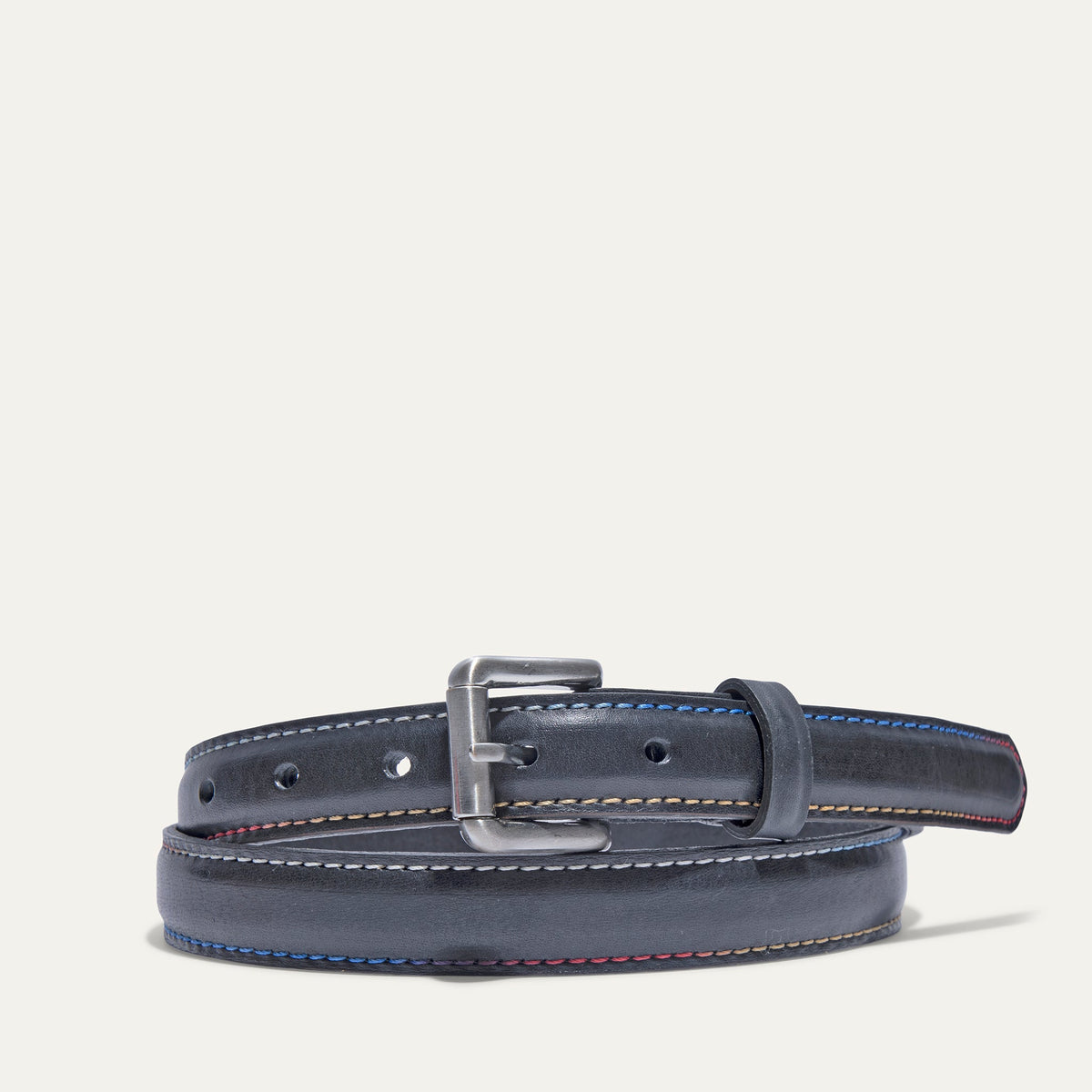 Rainbow Stitched Belt by WILL Leather Goods in navy leather with multicolor blue, tan, and red edge stitching, brushed nickel buckle, coiled front product view on a white background.