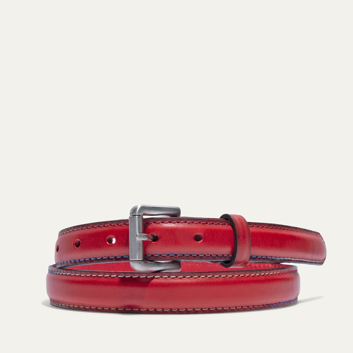 Rainbow Stitched Belt by WILL Leather Goods in red leather with multicolor blue, tan, and pink edge stitching, brushed nickel buckle, coiled front product view on a white background.