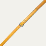 Close-up of the Rainbow Stitched Belt strap tip in yellow leather, showing the multicolor blue and red edge stitching and row of adjustment holes.