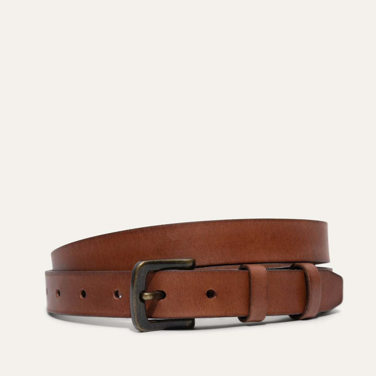 Cognac tan leather belt with double keeper loops and a brass buckle, coiled, front angled view.