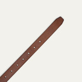 Close-up of cognac tan leather belt strap showing the pointed tip end with adjustment holes.