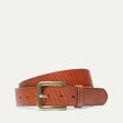 Razor Cut Belt by WILL Leather Goods in cognac leather with fine diagonal laser-cut striping, brass buckle, coiled front product view on a white background.
