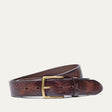 Dark brown leather belt coiled to show the brass buckle and fine embossed line texture running the length of the strap
