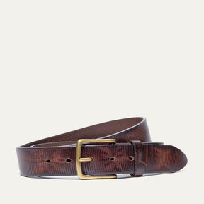 Dark brown leather belt coiled to show the brass buckle and fine embossed line texture running the length of the strap