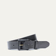 Will Leather Goods Leather Buckle Belt in black leather, coiled side view showing the brass roller buckle, on a white background.