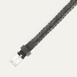 Close-up of the black Five Strand Braided Belt's brushed silver buckle and keeper loop, showing the five-strand leather braid detail.