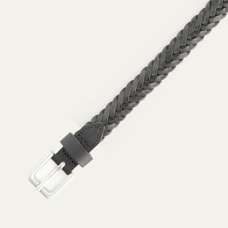 Close-up of the black Five Strand Braided Belt's brushed silver buckle and keeper loop, showing the five-strand leather braid detail.