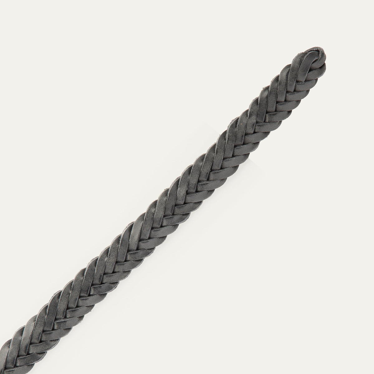 Close-up of the black Five Strand Braided Belt's rounded, buckle-free tip end, showing the five-strand leather braid.