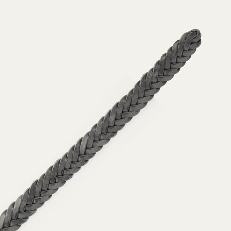 Close-up of the black Five Strand Braided Belt's rounded, buckle-free tip end, showing the five-strand leather braid.