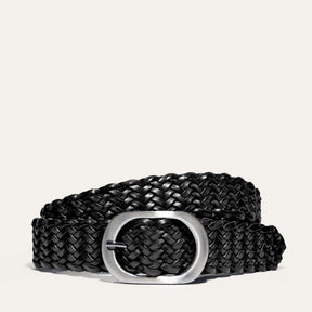 Will Leather Goods Twelve Strand Luxe Crafted Braided Belt in black leather, coiled on a white background with a brushed silver oval buckle.
