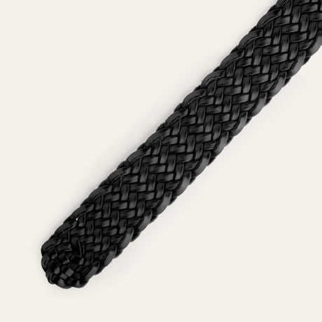 Close-up of the black Twelve Strand Braided Belt's rounded, buckle-free tip end, showing the twelve-strand leather braid.