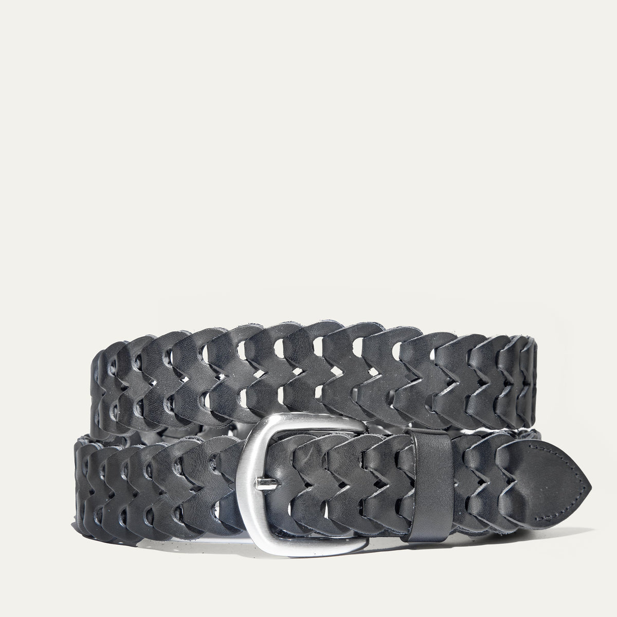 Black woven leather W Link belt coiled flat, showing the full herringbone braid and brushed silver buckle