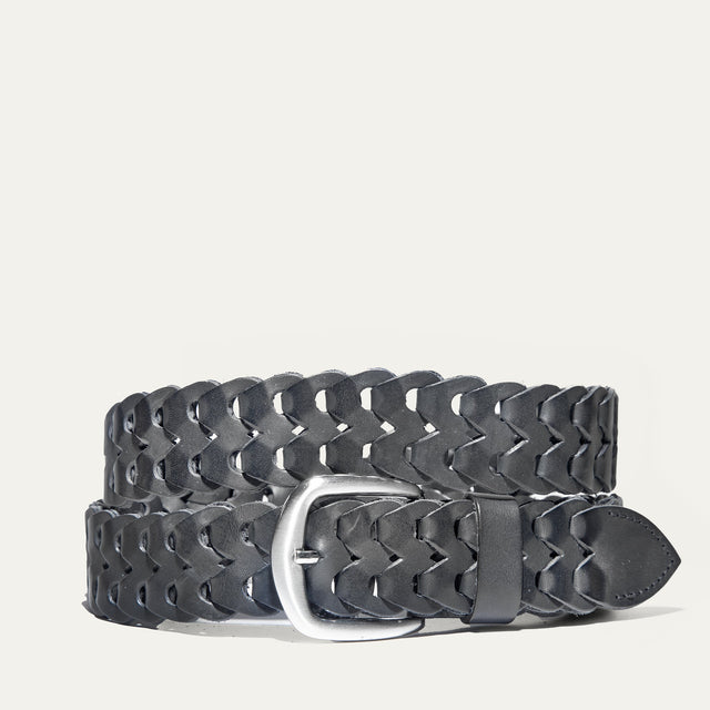 Black woven leather W Link belt coiled flat, showing the full herringbone braid and brushed silver buckle